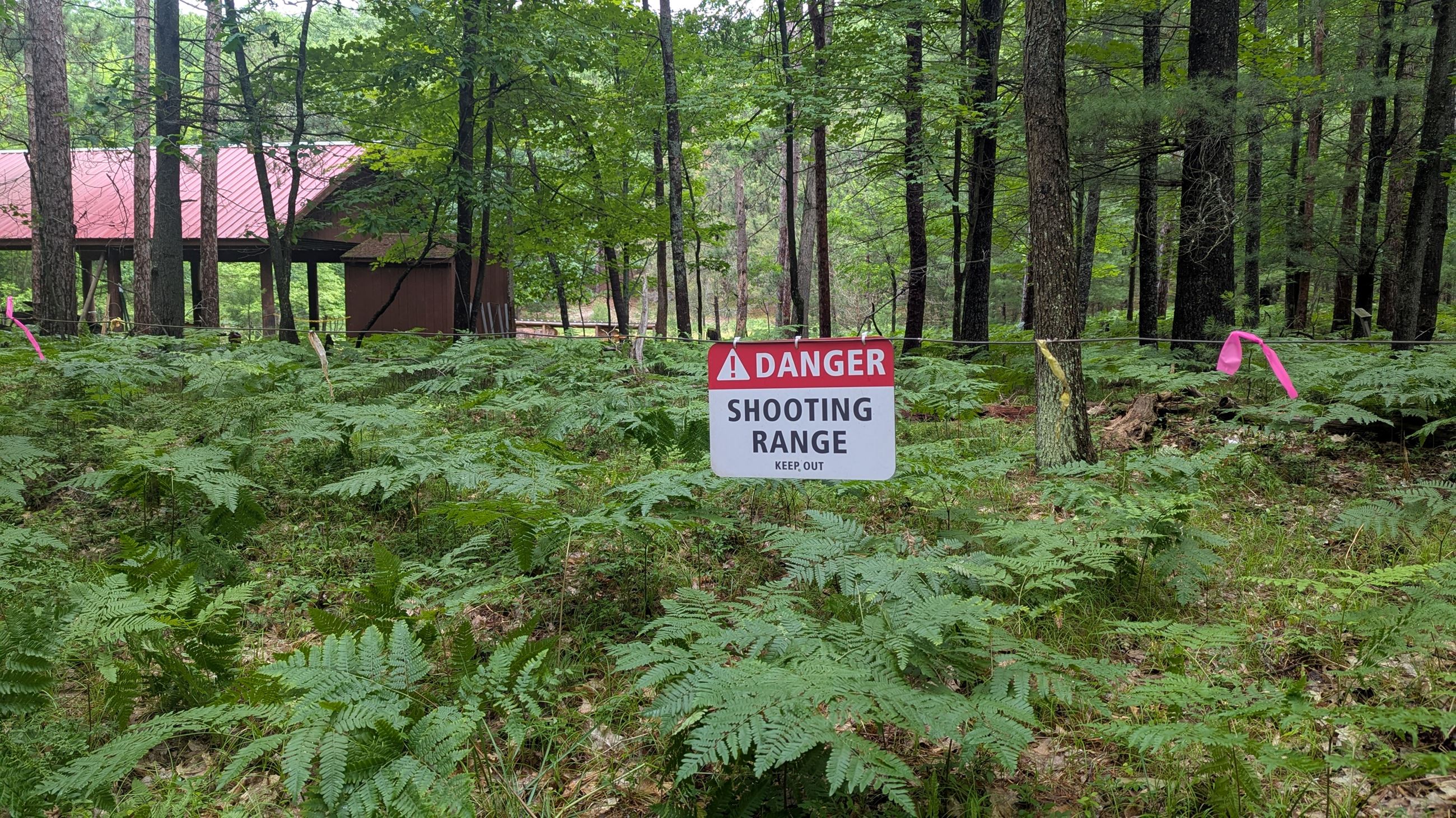 a sign that says danger shooting range